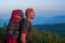 Hiker with backpack looks into the distance