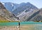 Hiker with backpack near Kulikalon lake on rocky mountain