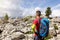 Hiker with a backpack standing in a field of rocks