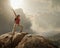 Hiker with backpack standing on top of a mountain