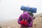 Hiker with a backpack under a cloudy sky trekking over the Andes mountains in Argentina