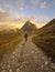 Hiker on a beautiful road in the mountains