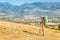 Hiker with big backpack stands on the rock and enjoys the valley view in Spanish Pyrenees mountains