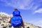 Hiker with big traveling rucksack looking forward on the mountain