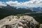 Hiker In Blue Hoodie Hunkers Down On The Windy Open Granite Of Lembert Dome