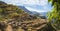 Hiker with camera among agriculture terraces nestled into the slopes of gorgeous mountains. Trekkingtrail Corda Coculli