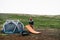 Hiker or camper sets up tent in epic scenery