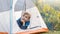 Hiker child boy sitting inside a tent in mountain campsite enjoying view of nature.