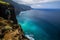 hiker on cliff, observing vast glowing ocean below