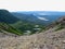 A hiker climbing a massive scree slope on the way to the summit of Gros Morne Mountain, in Gros Morne National Park, Newfoundland