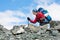 Hiker is climbing rocky slope of mountain in Altai mountains, Ru