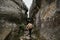 A hiker climbs a mountain gorge. Extreme rest