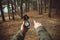 Hiker with compass pointing direction in the forest