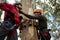 Hiker couple adjusting safety gear in the forest