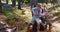 Hiker couple sitting on rock and looking at map