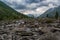 Hiker cross the mountain river