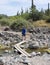 A Hiker Crosses Cave Creek, Spur Cross Ranch Conservation Area