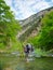 Hiker crosses a river