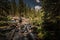 Hiker Crosses a stream near Mitchell Lake Colorado