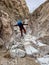 HIker Crossing Precarious Rocks Along Strawhouse Trail In Big Bend