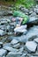 Hiker drinking water with creek.