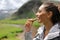 Hiker eating a cereal bar in the mountain