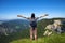 Hiker enjoying breathtaking landscape from top of cliff in Switzerland