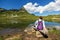 Hiker enjoying the peaceful scenery of Loser peak with mountain reflection in the Alpine lake Augstsee in the Austrian Alps near