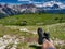 Hiker enjoying rest and amazing panoramic view of dolomites three peaks of lavaredo italy