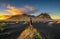 Hiker enjoying sunset at Vestrahorn and its black sand beach in Iceland