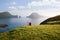 The hiker enjoys the beautiful nature of the Faroe Islands