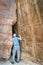 Hiker exploring a tight slot canyon