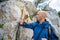 Hiker feeds young monkeys on a hiking trail in Gibraltar