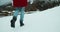 Hiker female walk on snow at the winter vacation mountain travel feet closeup