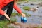 Hiker filling the canteen in a river