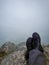 Hiker foot resting at mountain top from flat angle at morning