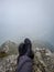 Hiker foot resting at mountain top from flat angle at morning