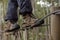 Hiker foot walking on zip line cable in the forest
