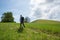 Hiker on footpath to drumlin hill. nature preserve for beautiful wildflowers, relict of the glacial period. spring landscape near