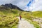 Hiker on the footpath to the famous rock Old Man of Storr, Isle of Skye, Scotland