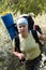 Hiker girl with backpack in flowers