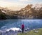 A hiker girl near mountain lake in Switzerland. Lake Oeschinensee in Swiss alps