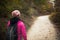 Hiker girl walking on a path in the mountains.