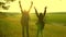 Hiker Girls teamwork. free traveler girls raise their hands up, celebrating victory and enjoying the scenery, in sun