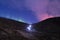 Hiker headlamps starburst volcano aurora