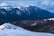 Hiker in the heart of mountains in winter with great mountains view behind