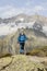 Hiker hikes through a breathtaking alpine landscape in the mountains