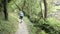 Hiker hiking along the Dortebachtal valley at Mosel valley Germany. German nature reservation with hiking trail names Eifelsteig