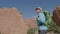 Hiker Hiking With Backpack Among Orange Rock Massifs In Arches National Park