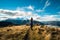 A hiker hiking on the beautiful track with a landscape of the mountains and Lake Wanaka. Roys Peak Track, South Island, New